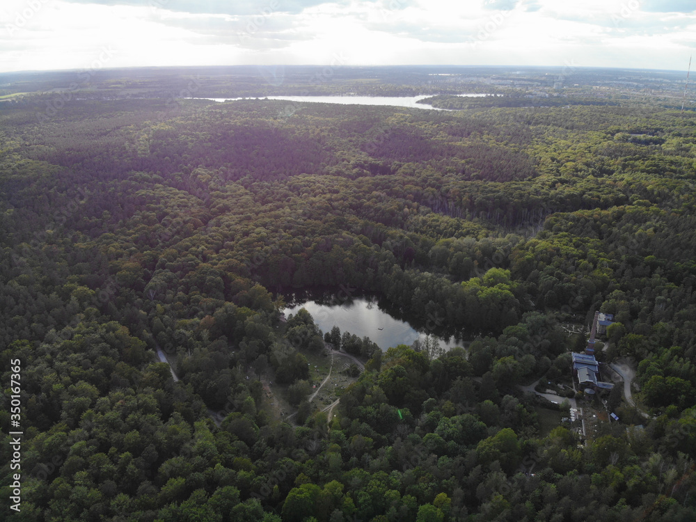 Fototapeta premium Aerial view of lake Teufelssee a glacial lake in the Grunewald forest in the Berlin borough of Charlottenburg-Wilmersdorf.