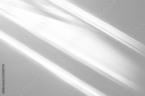 Overlay effect for photo and mockups. Organic drop diagonal shadow and rays of light from window on a white wall. shadows for natural light effects
