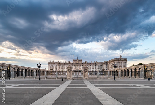 Royal palace in Madrid, at the sunset with dramatic sky and no people around
