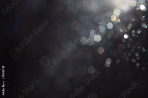 bokeh of water fly and lights on black background,