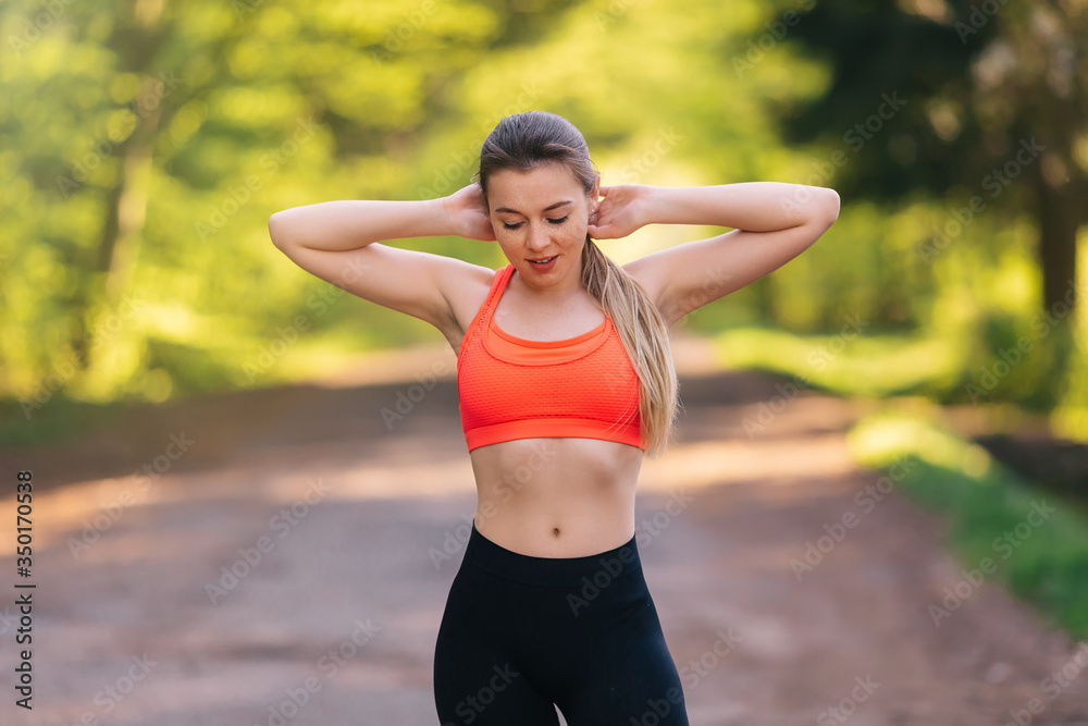 Attractive girl dressed in a sports pink top doing sport outdoor Attractive girl dressed in a sports pink top doing sport outdoor