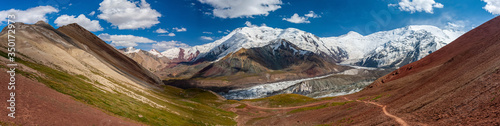 Snowy mountain peaks. Scenic landscape. Beautiful nature. Red sand. Panorama view.