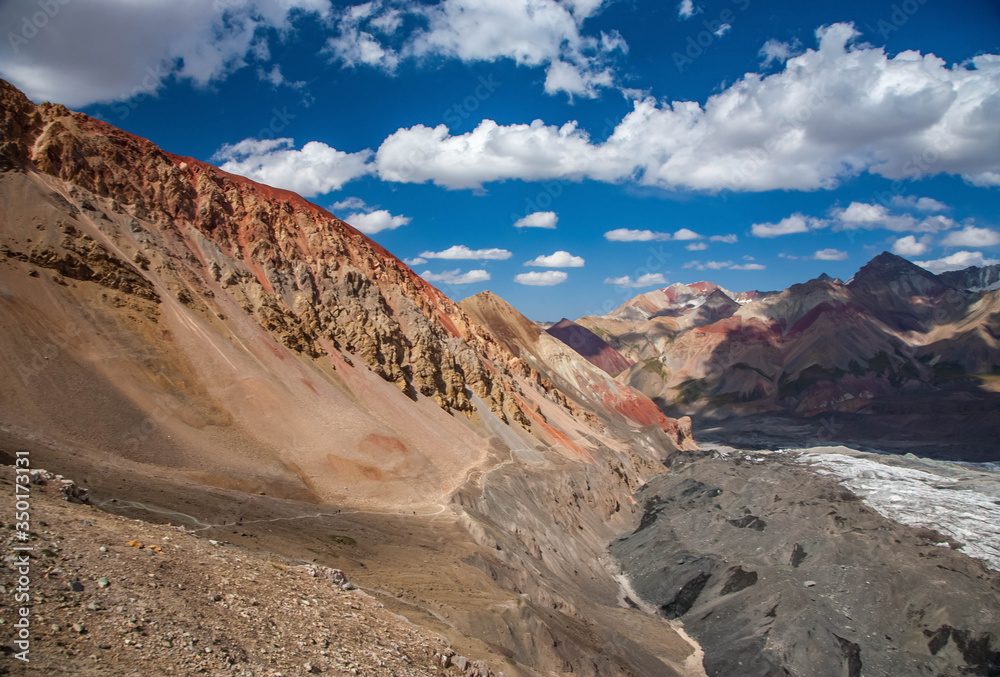 Fototapeta premium Beautiful landscape of mountain peaks. Hilly area. Mountainious terrain. Red sand.