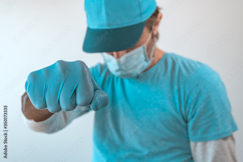 Delivery man during pandemic lockdown gesturing fist bump Delivery man during pandemic lockdown gesturing fist bump