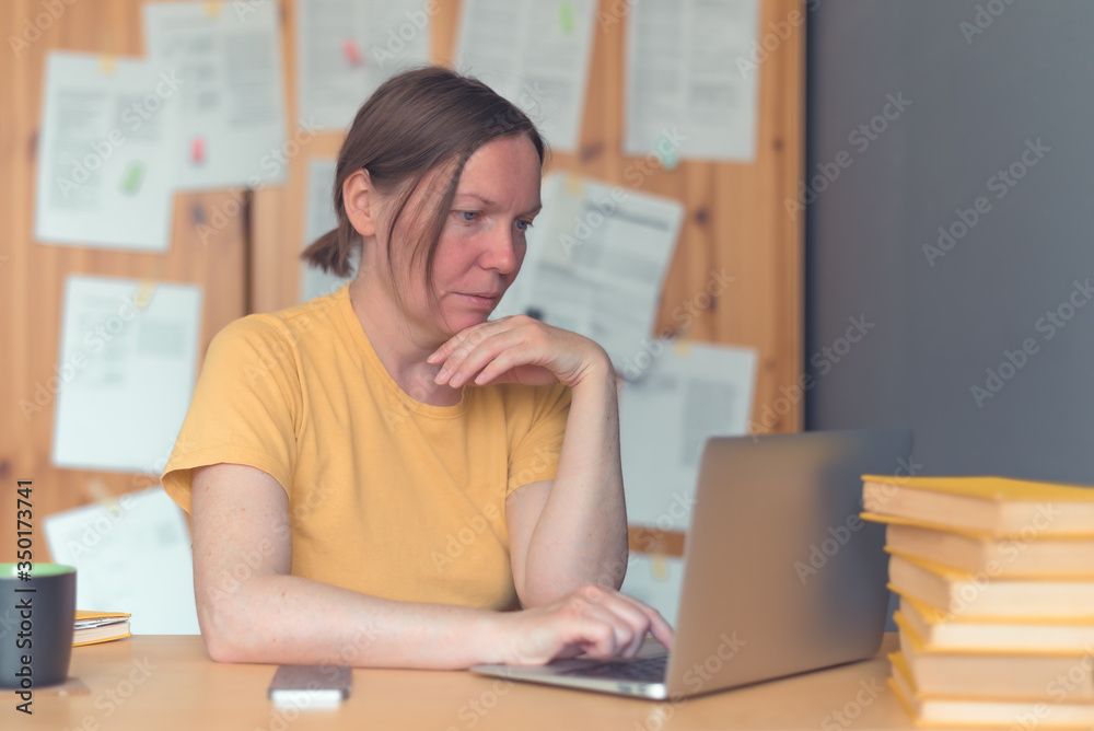 Female freelancer working from home on laptop computer