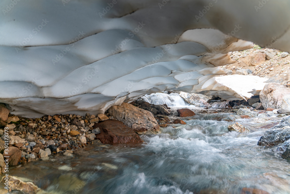 The beautiful view of frozen glacier and Kaznok river neat to Zmeya peak in Fann mountains in Tajikistan The beautiful view of frozen glacier and Kaznok river neat to Zmeya peak in Fann mountains in Tajikistan