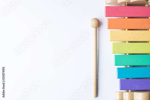 children's musical multi-colored wooden instrument xylophone on a white background