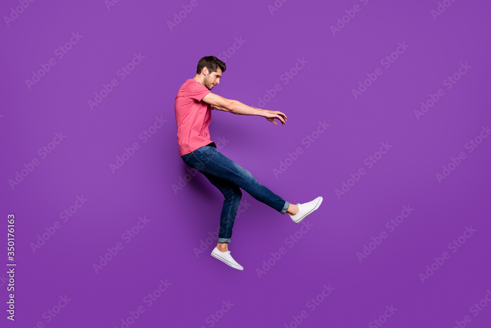 Full length profile side photo of minded guy jump wind blow he fall fly lose gravity weightlessness wear good look clothes gumshoes isolated over bright color background