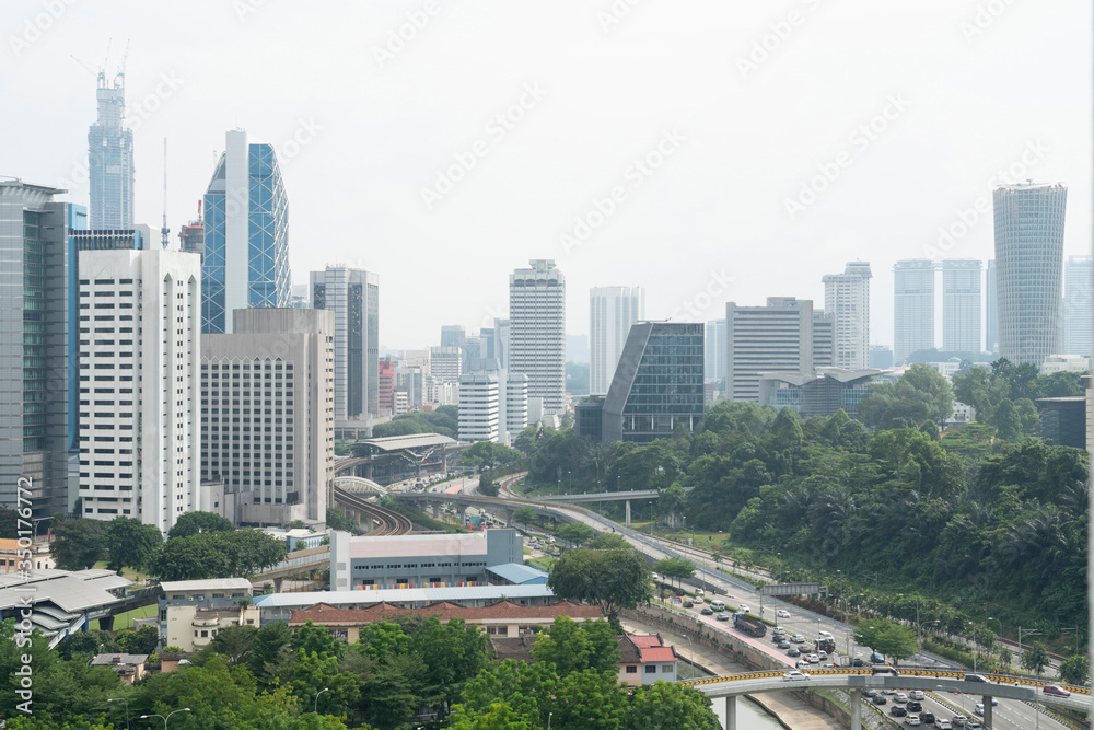 Panoramic view of Kuala Lumpur skyline at day time. City center of capital of Malaysia. Contemporary buildings exterior with glass.