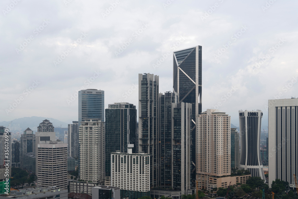 Panoramic view of Kuala Lumpur skyline at day time. City center of capital of Malaysia. Contemporary buildings exterior with glass.