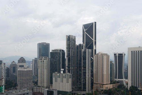 Panoramic view of Kuala Lumpur skyline at day time. City center of capital of Malaysia. Contemporary buildings exterior with glass.