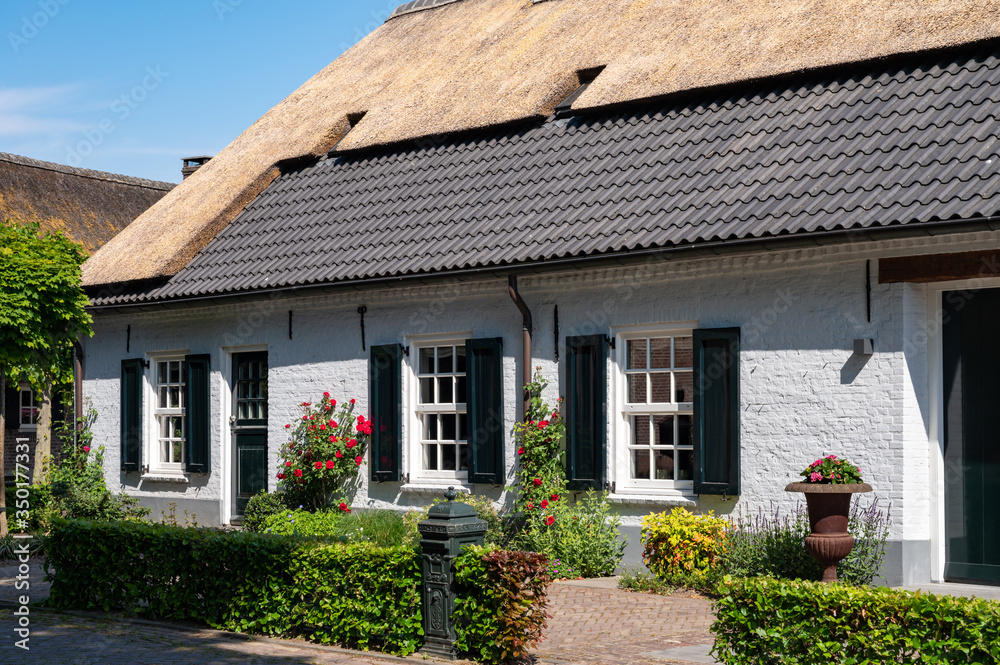 View on old Dutch house with thatched roof in North Brabant, Netherlands