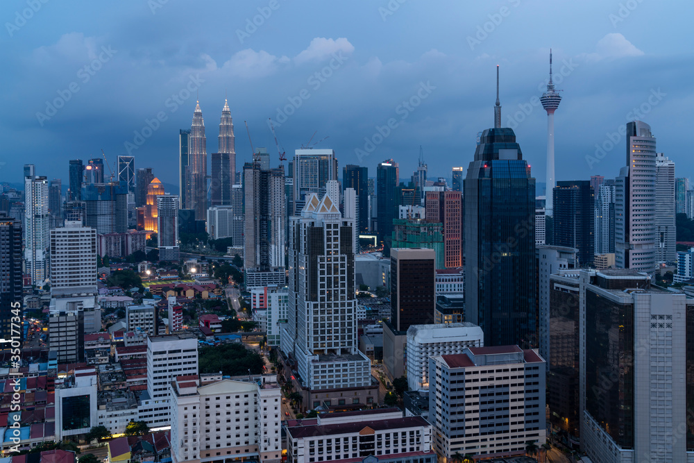 Fototapeta premium Panoramic view of Kuala Lumpur skyline at night time. City center of capital of Malaysia. Illumination lights contemporary buildings exterior with glass.