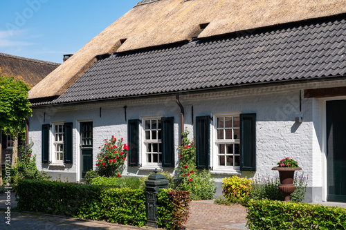 View on old Dutch house with thatched roof in North Brabant, Netherlands photo