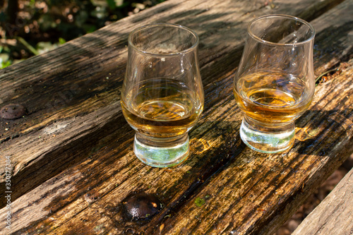 Tasting of different Scotch whiskies on outdoor terrace, dram of whiskey © barmalini