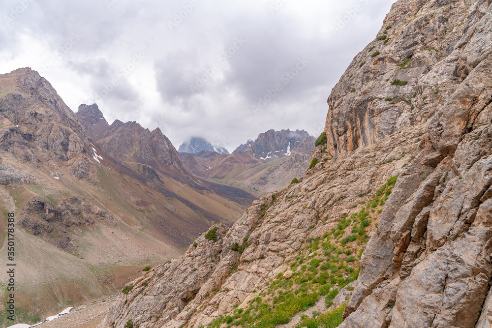 The beautiful view of blue sky and snow mountain summit near to Zmeya peak in Fann mountains in Tajikistan