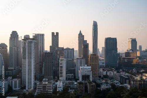 Panoramic view of Bangkok skyline at sunset. Modern city center of capital of Thailand. Contemporary buildings exterior with glass.