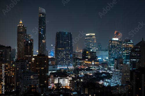 Panoramic view of Bangkok skyline at night time. Illuminated city center of capital of Thailand. Contemporary buildings exterior with glass. © VideoFlow