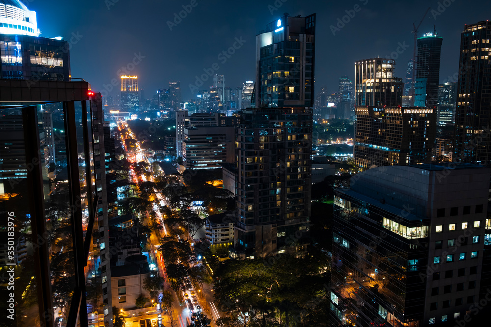 Obraz premium Panoramic view of Bangkok skyline at night time. Illuminated city center of capital of Thailand. Contemporary buildings exterior with glass.