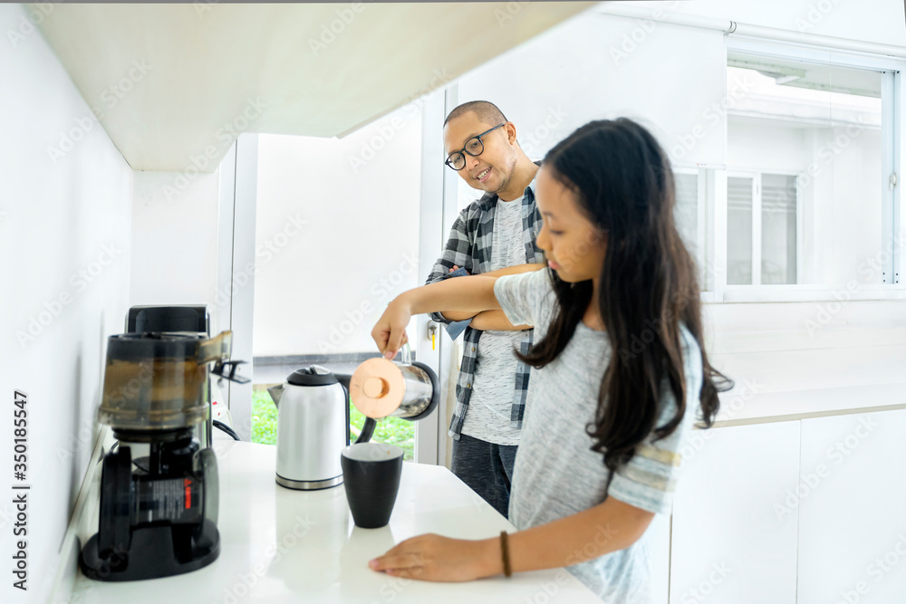 Little girl making coffee for her father at home Little girl making coffee for her father at home