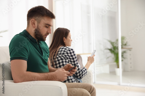 Couple addicted to smartphones at home. Relationship problems © New Africa