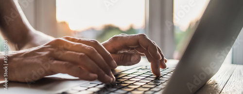 Man hands typing on computer keyboard closeup, businessman or student using laptop at home, panoramic banner, online learning, internet marketing, working from home, office workplace freelance concept