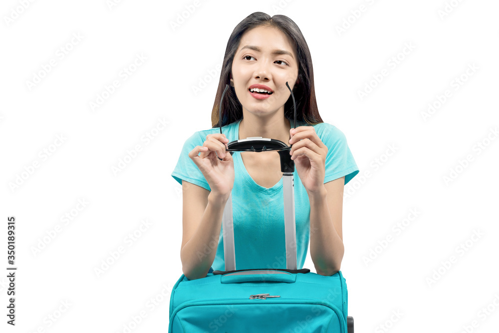 Asian woman with sunglasses leaning on suitcase Asian woman with sunglasses leaning on suitcase