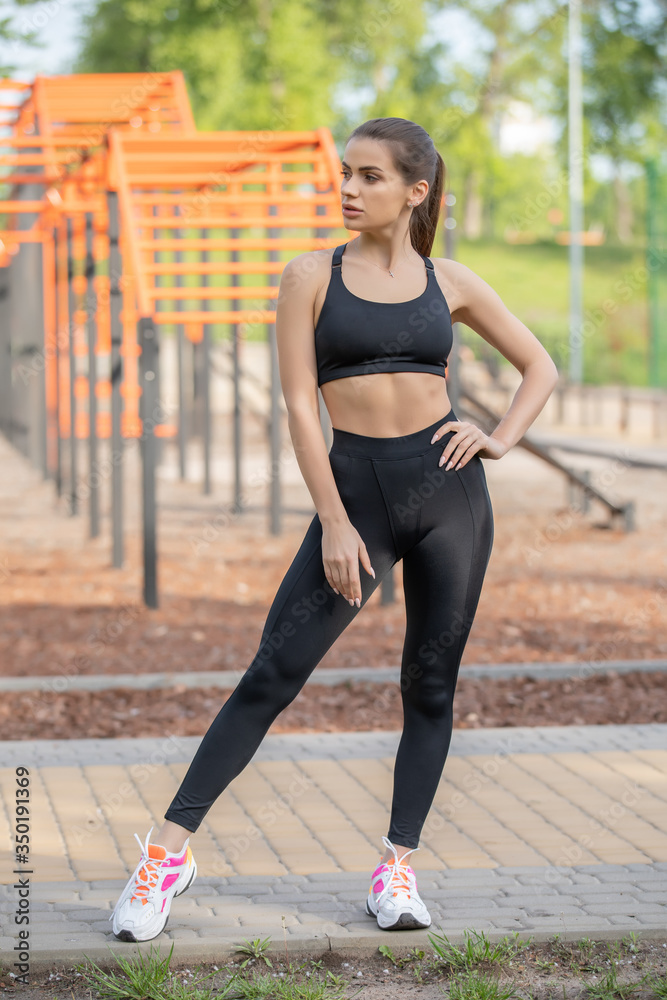 Fototapeta premium Pretty sporty girl workout outdoor on the sports ground. healthy lifestyle