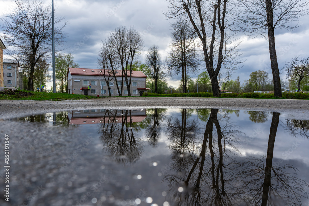 Street view with water reflection after rain in Estonia. Summer Rain Showers, urban view. Old soviet town. Street view with water reflection after rain in Estonia. Summer Rain Showers, urban view. Old soviet town.