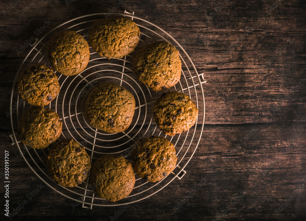
Ten delicious fresh cookies on a metal stand. Wood background. Aerial view.