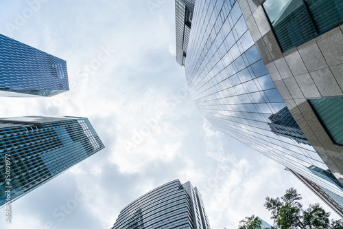 Low-angle view of picturesque skyscrapers of Singapore city downtown at day time. Financial district and trading center hub in Asia region. Concept of success. Modern buildings in high-tech world. © VideoFlow
