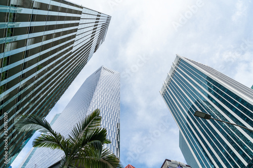 Low-angle view of picturesque skyscrapers of Singapore city downtown at day time. Financial district and trading center hub in Asia region. Concept of success. Modern buildings in high-tech world.