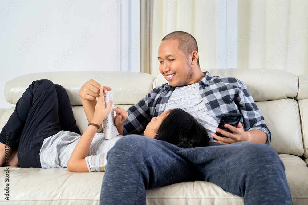 Father and child enjoying leisure time on couch Father and child enjoying leisure time on couch