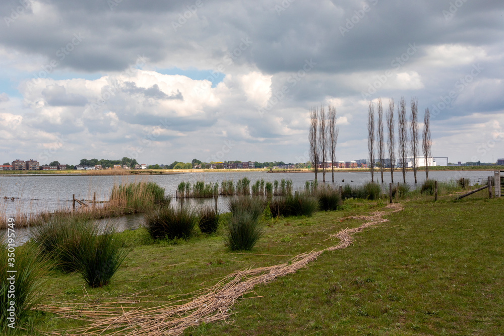 Landscape with blue sky and clouds between Ridderkerk and H.I. Ambacht . The Netherlands Landscape with blue sky and clouds between Ridderkerk and H.I. Ambacht . The Netherlands