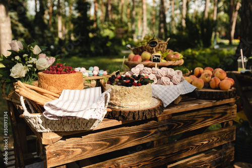 at the wedding party there are delicious cakes and sweet peaches and other different fruits