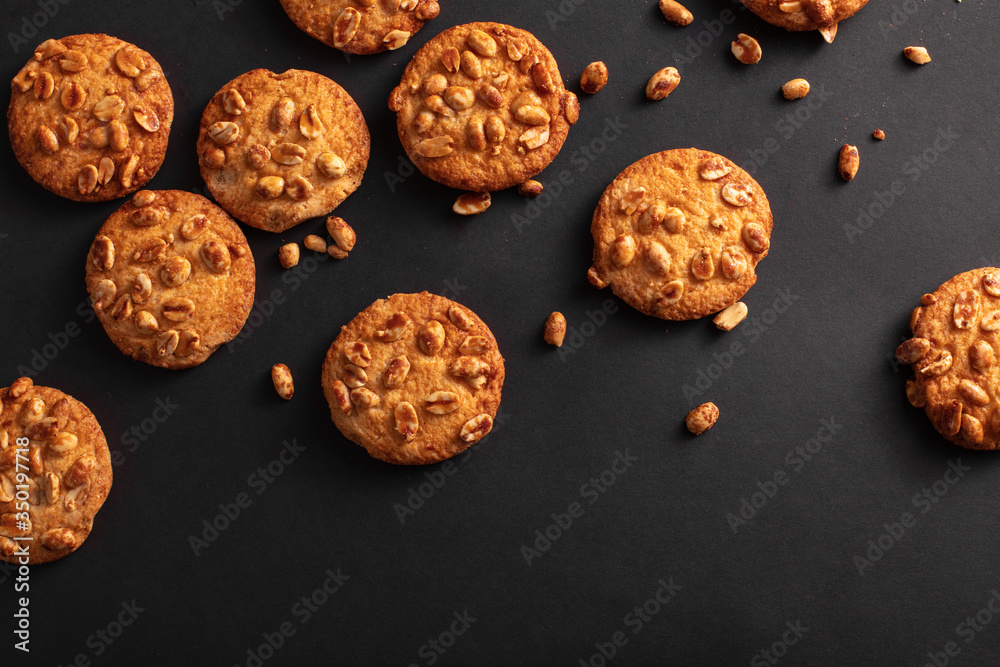 Background from cookies with nuts top view. The dark background and cookies with crumbs on a black background. Background from cookies with nuts top view. The dark background and cookies with crumbs on a black background.