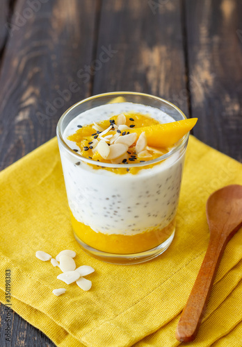Yogurt in a glass with mango, chia and almonds. Healthy eating. Vegetarian food. Recipe. Breakfast. Diet.