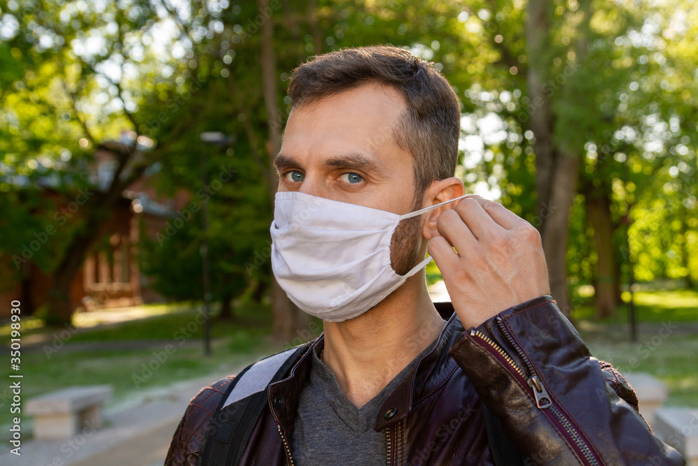 Masked man in the park. A man with a phone walks in the park. covid-19, coronavirus, pandemic.
Masked man in the park. A man with a phone walks in the park. covid-19, coronavirus, pandemic.