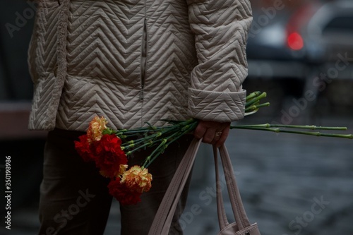 woman holding carnations
