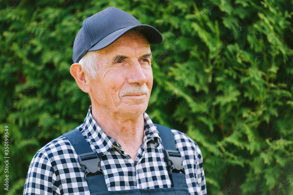 Senior professional worker in overall and cap. Aged farmer. Old craftsman. Senior professional worker in overall and cap. Aged farmer. Old craftsman.