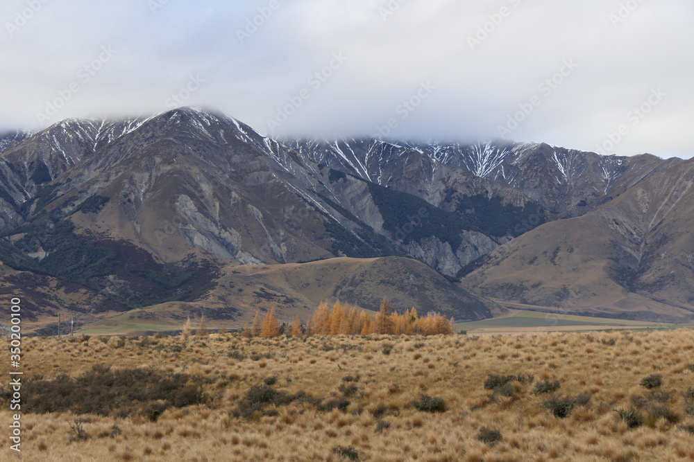 Rugged wilderness and scenic panorama with cloud-covered peaks in the New Zealand Southern Alps