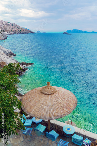 Hydra, Attica / Greece - June 6, 2010: Bar terraces facing the turquoise waters of the Aegean Sea