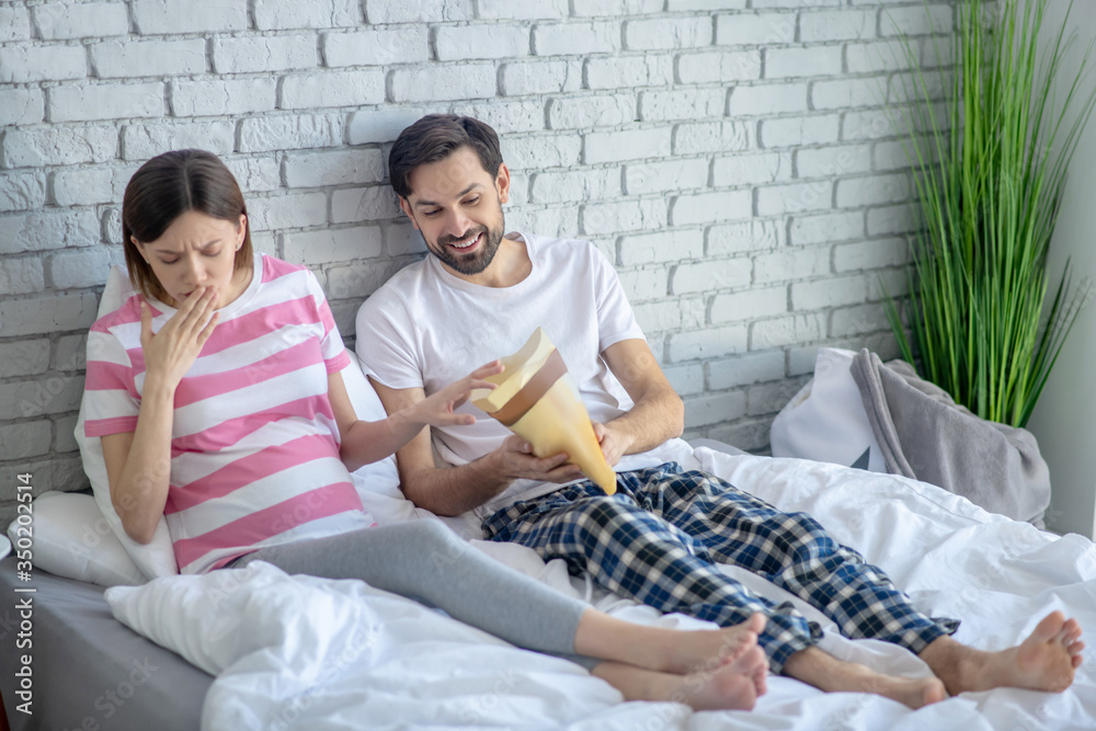 Young pregnant woman in a striped tshirt feeling nausea after eating Young pregnant woman in a striped tshirt feeling nausea after eating