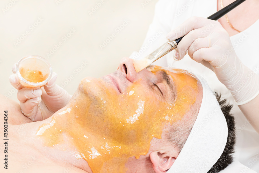 Man in the mask cosmetic procedure in spa salon Man in the mask cosmetic procedure in spa salon