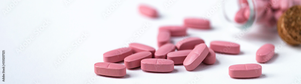 Concept of anti virus treatment treatment. Modern pills effective agains serious disease. Natural and synthetic composition. White background, close up, macro. Copy space for text. Banner Concept of anti virus treatment treatment. Modern pills effective agains serious disease. Natural and synthetic composition. White background, close up, macro. Copy space for text. Banner