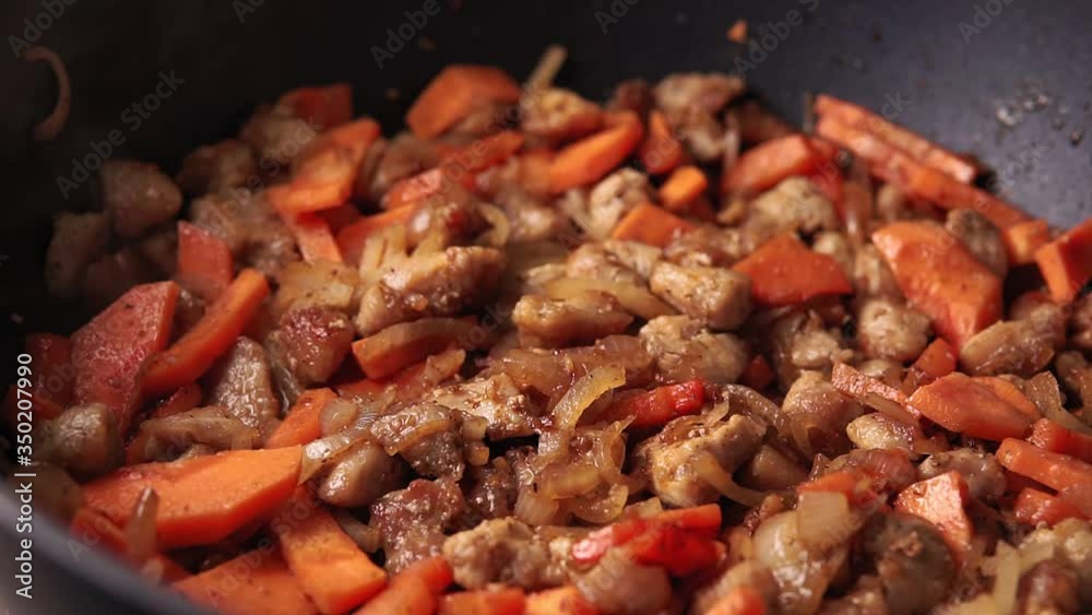 roast meat pork with carrots in a pan, the process of cooking pilaf roast meat pork with carrots in a pan, the process of cooking pilaf