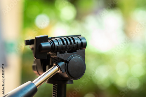 Plastic tripod camera mount head with a fast detach plate and a metal handle