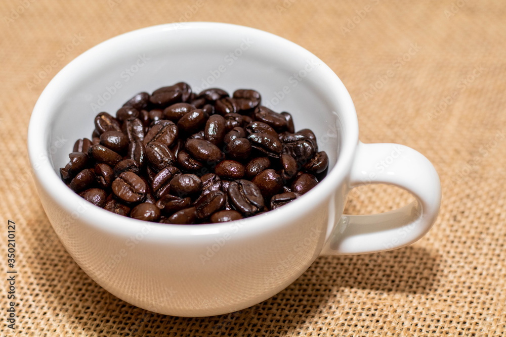 Cup of coffee with coffee beans on old background Cup of coffee with coffee beans on old background