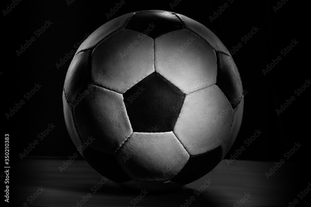 Fototapeta premium Soccer ball. Professional sport equipment isolated on black studio background. Concept of sport, leadership, competition, healthy lifestyle in motion and action, training. Close up, copyspace.