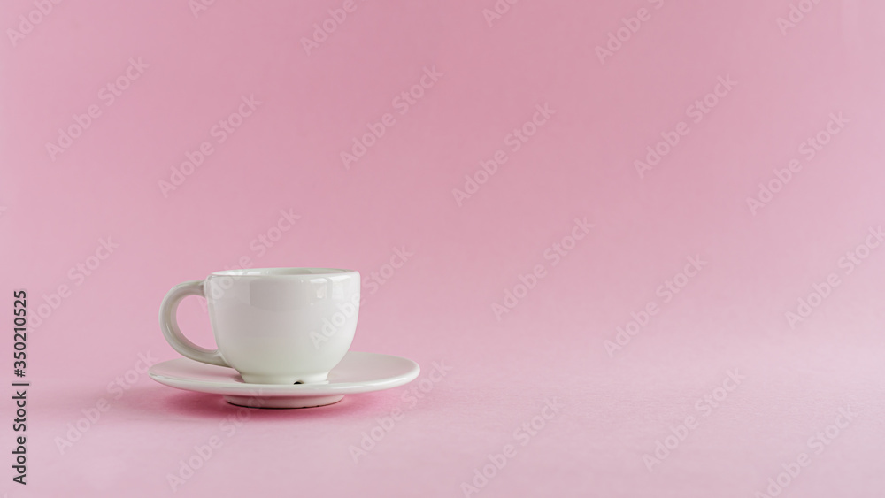 White coffee cup on pink background for drinks, beverage, utensil and dishware concept White coffee cup on pink background for drinks, beverage, utensil and dishware concept